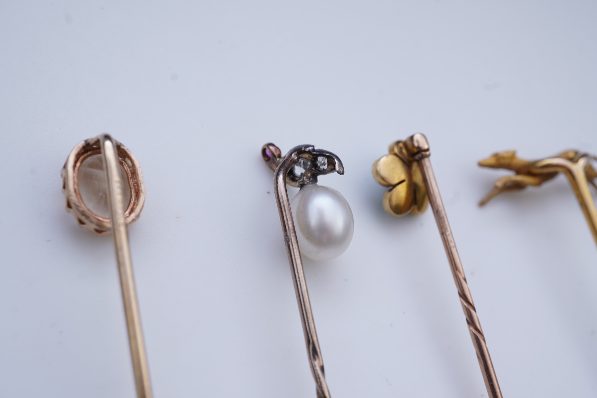 A collection of four tie pins, circa 1900